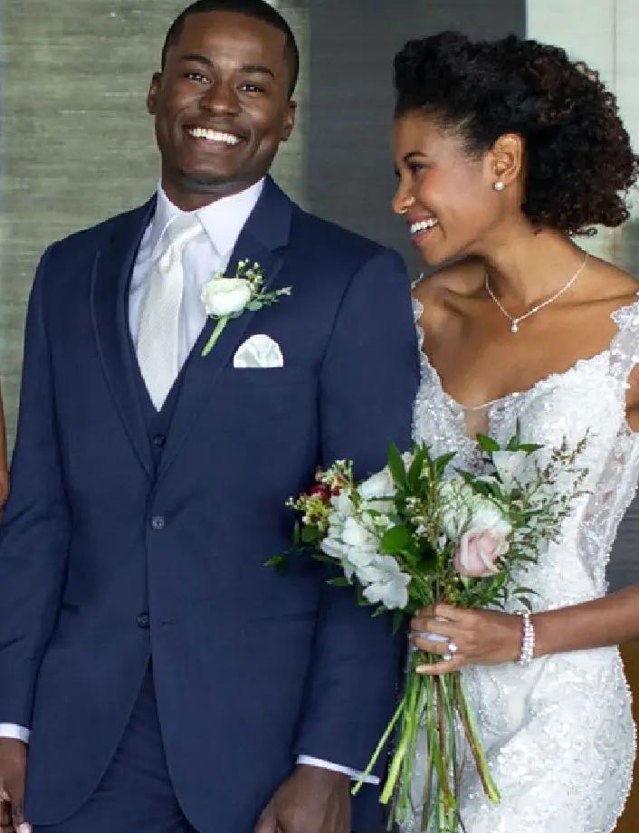 man in a tuxedo with a bride in a wedding gown